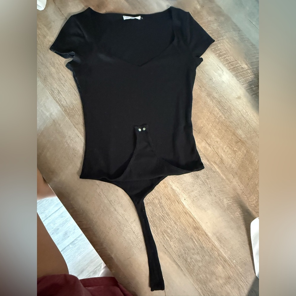 Elodie from Lulus Black Fitted short sleeve Bodysuit with Buttoned Closure